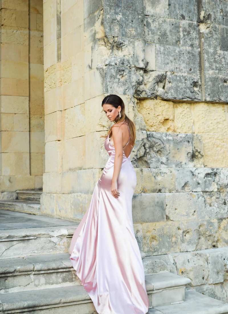 Woman wearing a blush silk evening dress